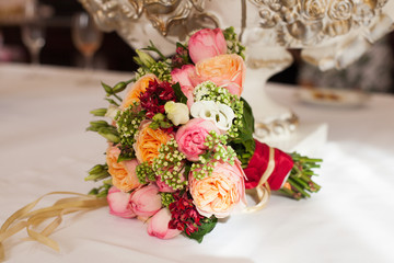 bridal bouquet of roses, buttercups and other flowers