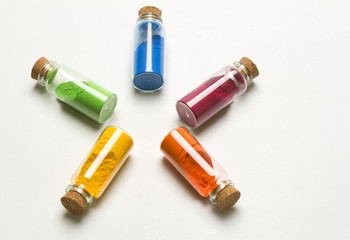 Glass bottles filed with colored powder