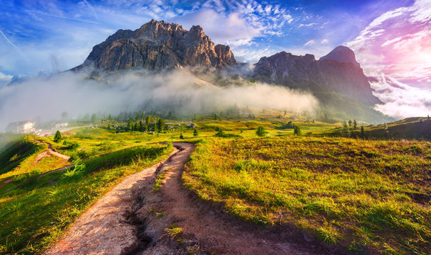 Tofane mountain range at sunny foggy morning. View from Falzareg