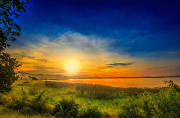 Fototapeta na wymiar Landscape Sunrise-sunset reflection on calm lake Green