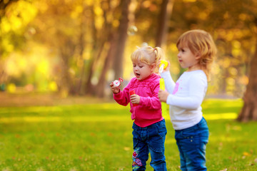 Fototapeta premium Happy kids with soap bubbles in the park. fun,emotions