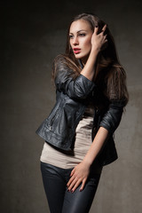 attractive woman in black leather jacket and pants