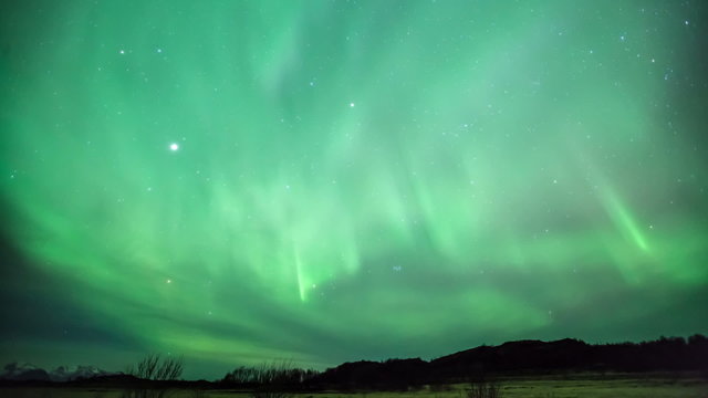 Northern lights aurora borealis in the night sky over beautiful
