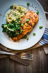 Salmon steak with mashed potatoes and greens