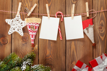 Snow fir tree, photo frames and christmas decor on rope