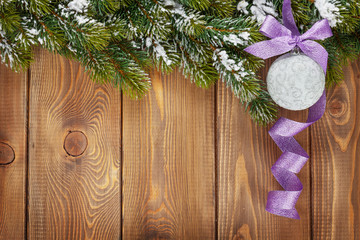 Christmas fir tree and bauble with purple ribbon