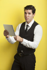businessmen on yellow background holding tablet