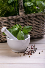 mortar and pestle - herbs and spices, fresh basil and parsley