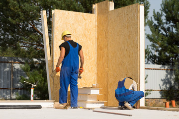 Male Construction Workers Building a House