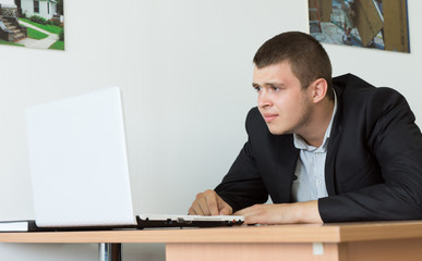 Serious Businessman Browsing Using Laptop