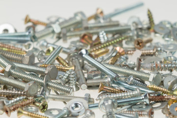 Screws, nuts, and bolts on isolated white background