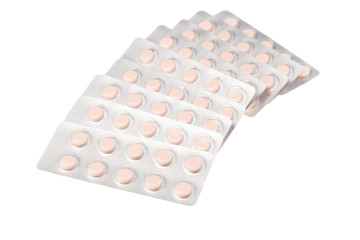 Tablets in bubble packaging on white background