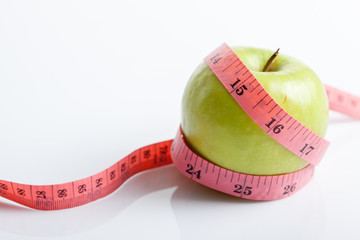 Measuring tape with green apple