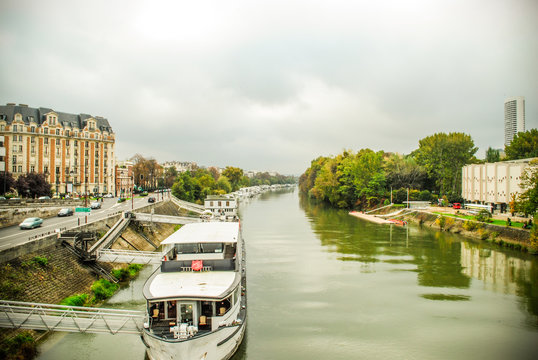 river Seine with docking boats and forest .,Paris. France.