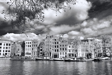 Amsterdam city with boats on canal in Holland