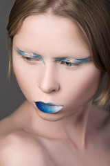 Portrait of young beautiful girl with blue lips