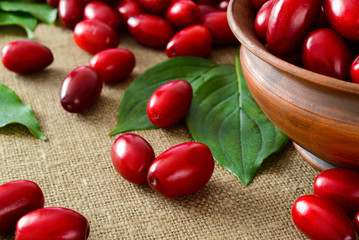 fresh cornel berries in brown bowl