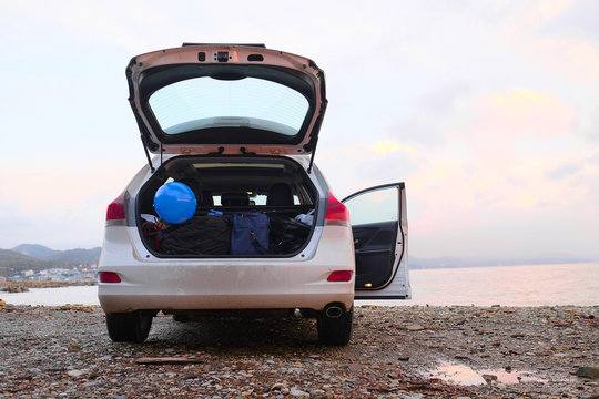 Car With Open Trunk On A Sea Coast