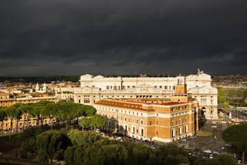 Fototapeta na wymiar Rome buildings against dark clouds