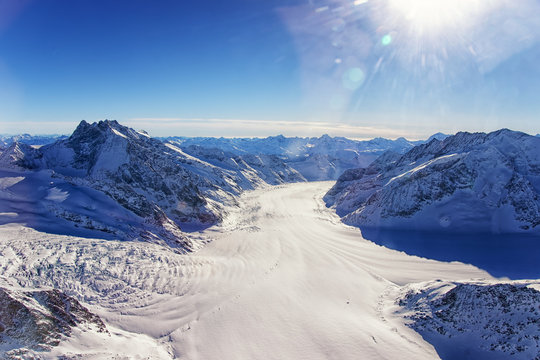 Swiss Aletch glacier crossing flows helicopter view in winter