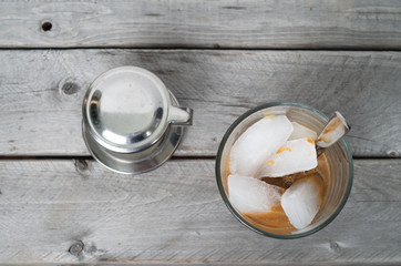 Vietnamese ice coffee with condensed milk, cafe sua da on a wood