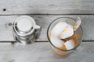 Vietnamese ice coffee with condensed milk, cafe sua da on a wood