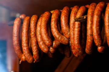 Traditional food. Smoked sausuages in smokehouse.