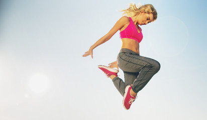 Portrait of jumping fit woman