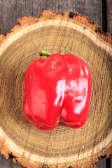 Fresh red bell pepper on wooden background