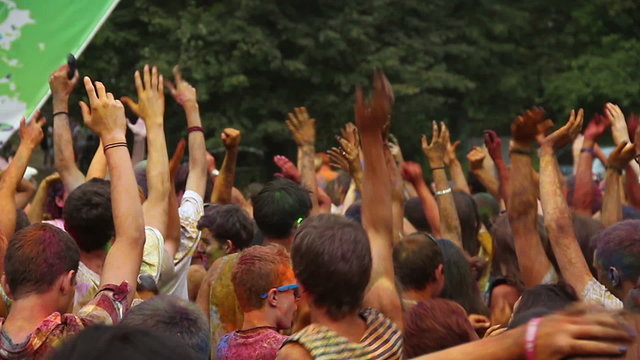 Crowd waving hands in the air, festival atmosphere, dancing