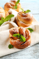 Tasty buns with berries on table close-up