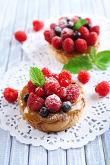 Sweet cakes with berries on table close-up