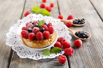 Sweet cakes with berries on table close-up