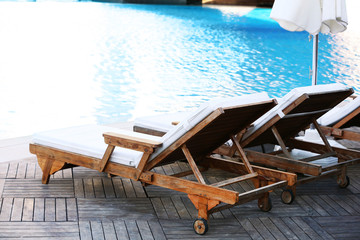Lounge sunbeds near swimming pool