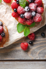 Sweet cakes with berries on table close-up
