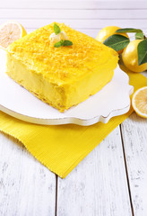 Tasty lemon cake on wooden table