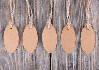 Brown tags on wooden background