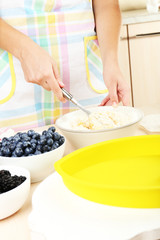 Baking tasty pie and ingredients for it on table in kitchen