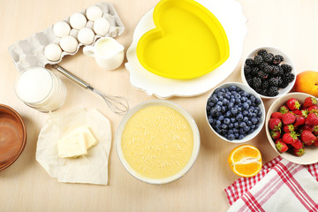 Baking tasty pie and ingredients for it on table in kitchen