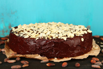 Tasty chocolate cake with almond, on old wooden table