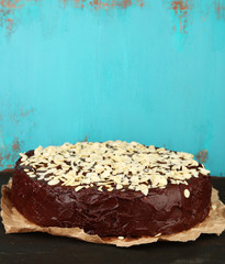 Tasty chocolate cake with almond, on old wooden table