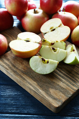 Juicy apples on wooden table, close-up