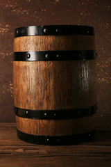 Fototapeta premium Barrel on wooden table on wooden wall background