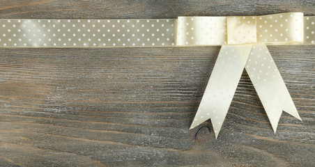 Old wooden background with beautiful bow