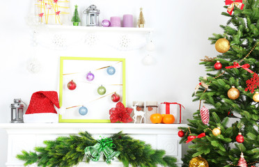 Christmas tree near fireplace in room