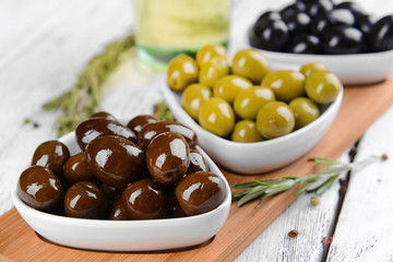 Different marinated olives on table close-up