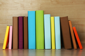 Books on wooden shelf close-up