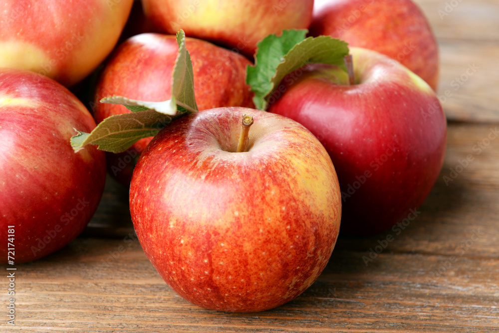 Wall mural Ripe red apples on wooden background