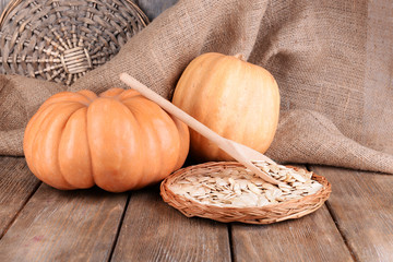 Pumpkins and seeds on wooden background