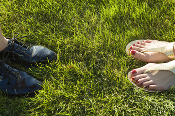 Two women of shoes that stand in the lawn